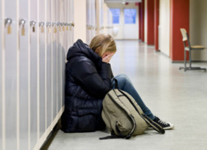 Young woman crying at school